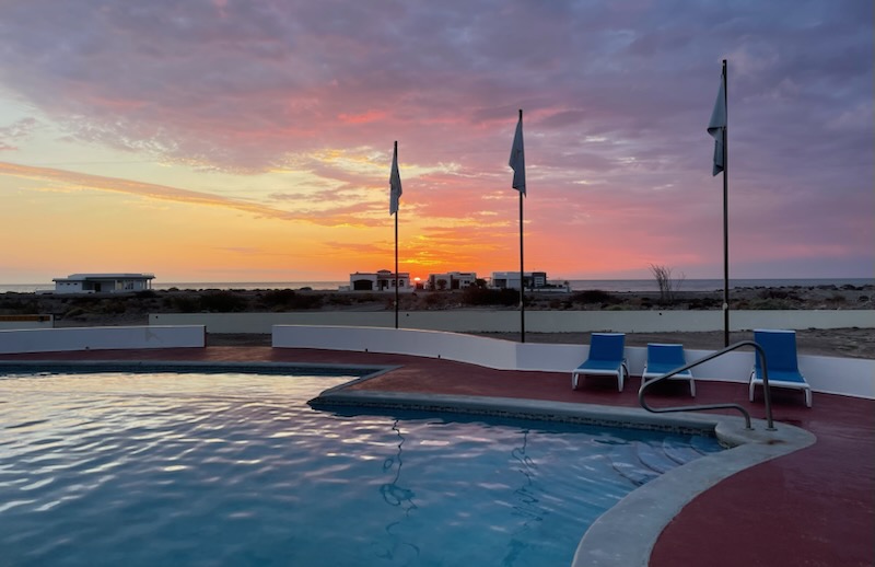 Infinity pool at sunset overlooking beachfront homes on the Sea of Cortez, Rancho Costa Verde